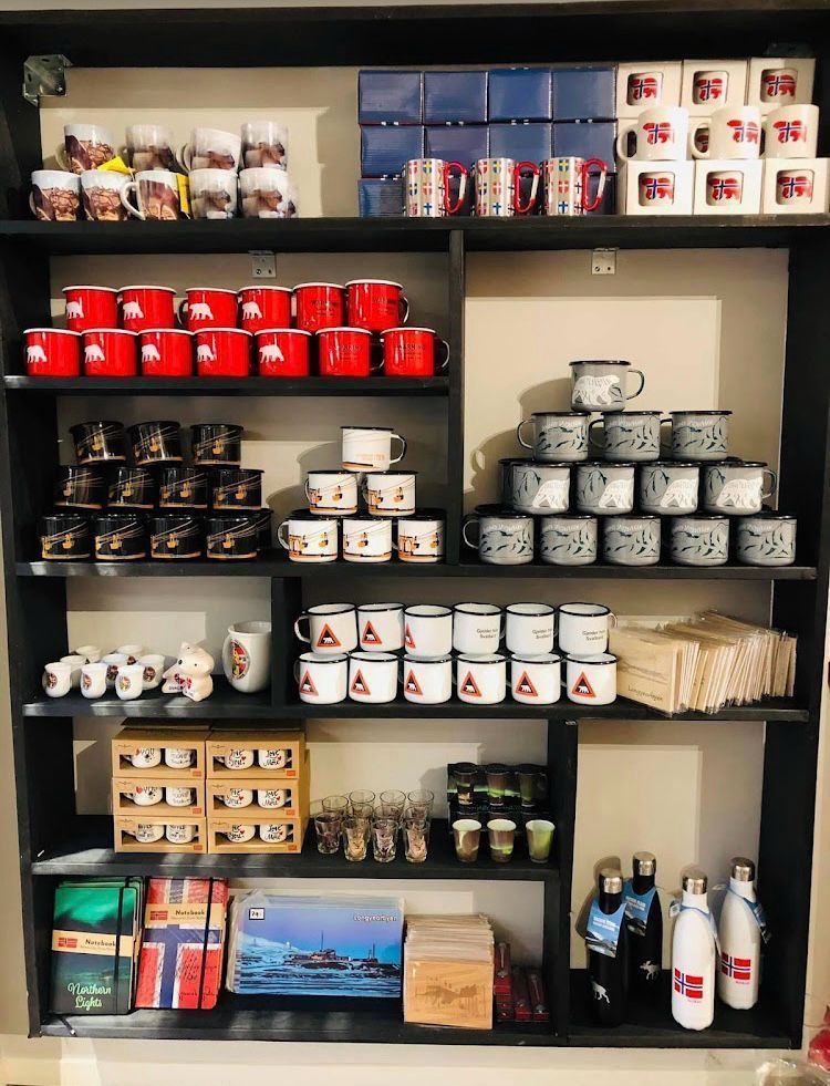 A shelf full of coffee mugs and other items
