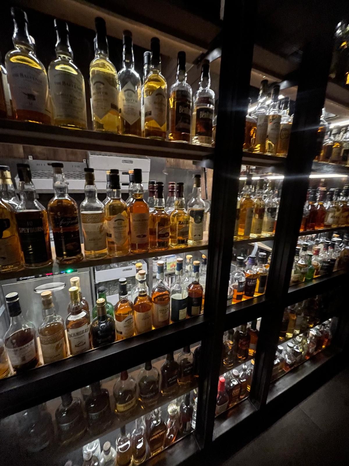 A bartender is shaking a drink in a bar.