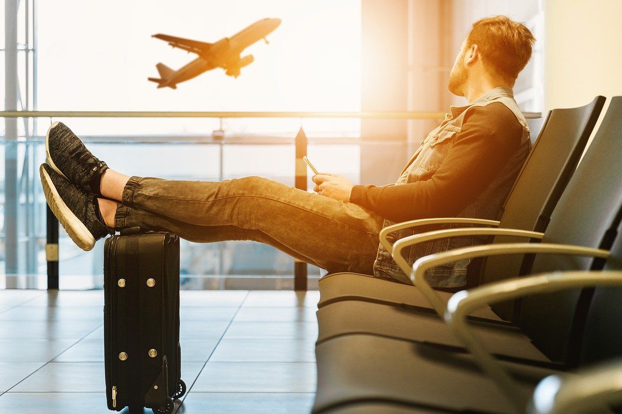 a guy sitting on an airport