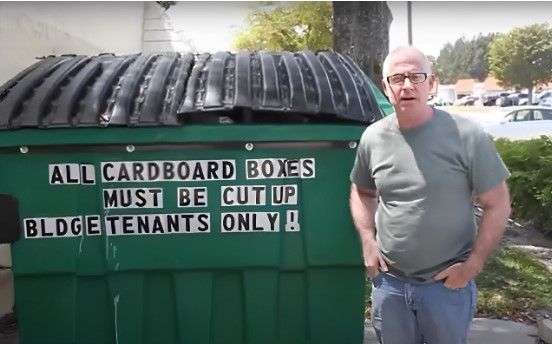 Person Standing Beside an 8-Yard Dumpster