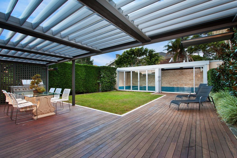 A wooden deck with a pergola over it