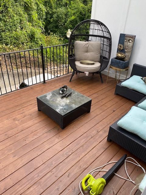 A wooden deck with a chair and a table on it