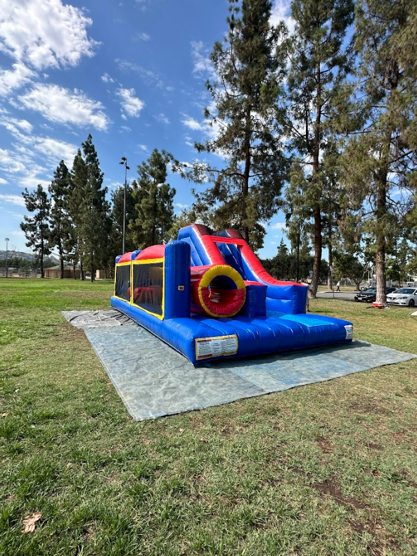 A large bouncy house is sitting in the middle of a park.
