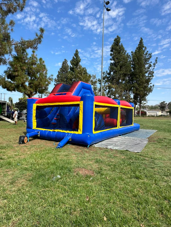 A large bouncy house is sitting on top of a lush green field.