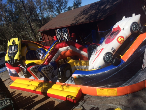 A large inflatable slide with cars on it and the number 5 on it