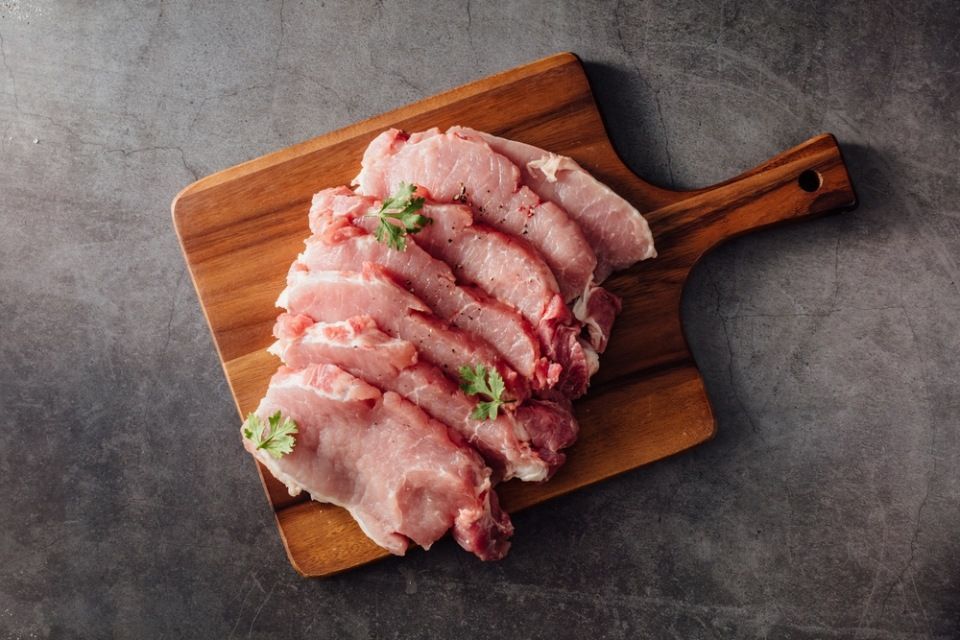 Pork made into steak pieces on black background