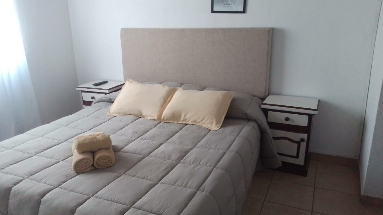 A bedroom with a large bed and two nightstands
