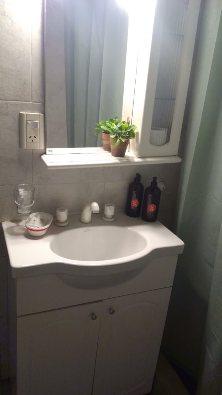 A bathroom with a sink and a mirror.