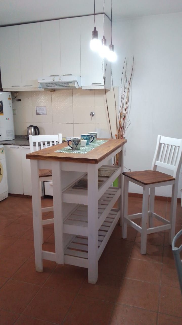 A kitchen with a table and chairs in it