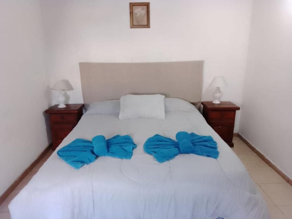 A bedroom with a bed and two nightstands