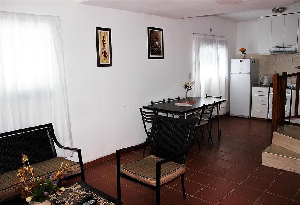 A living room with a couch a table and chairs