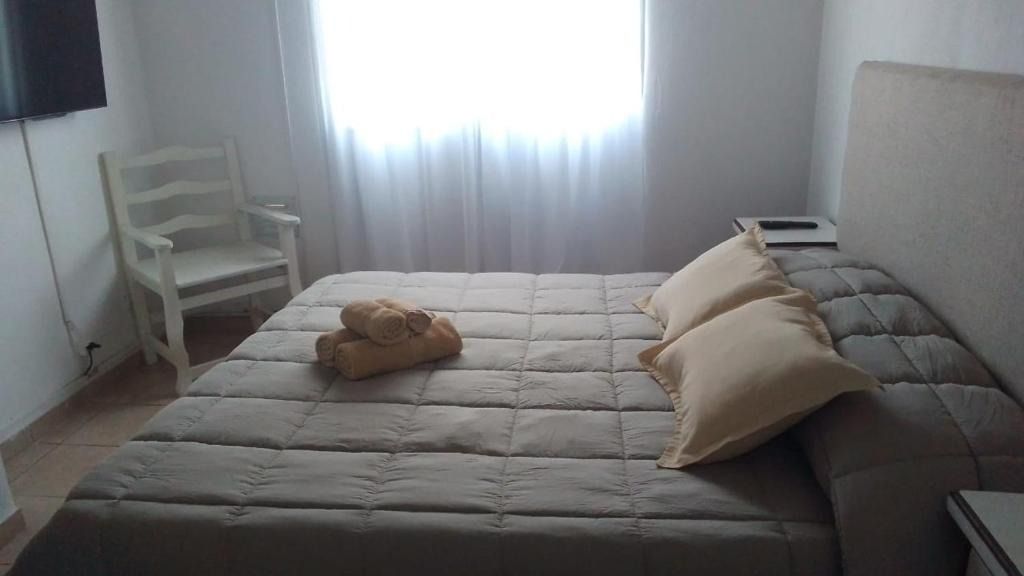 A bedroom with a bed , chair and television.