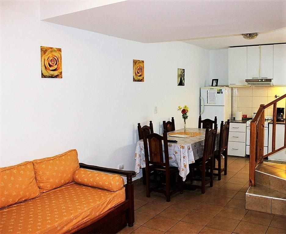 A living room with a couch a table and chairs