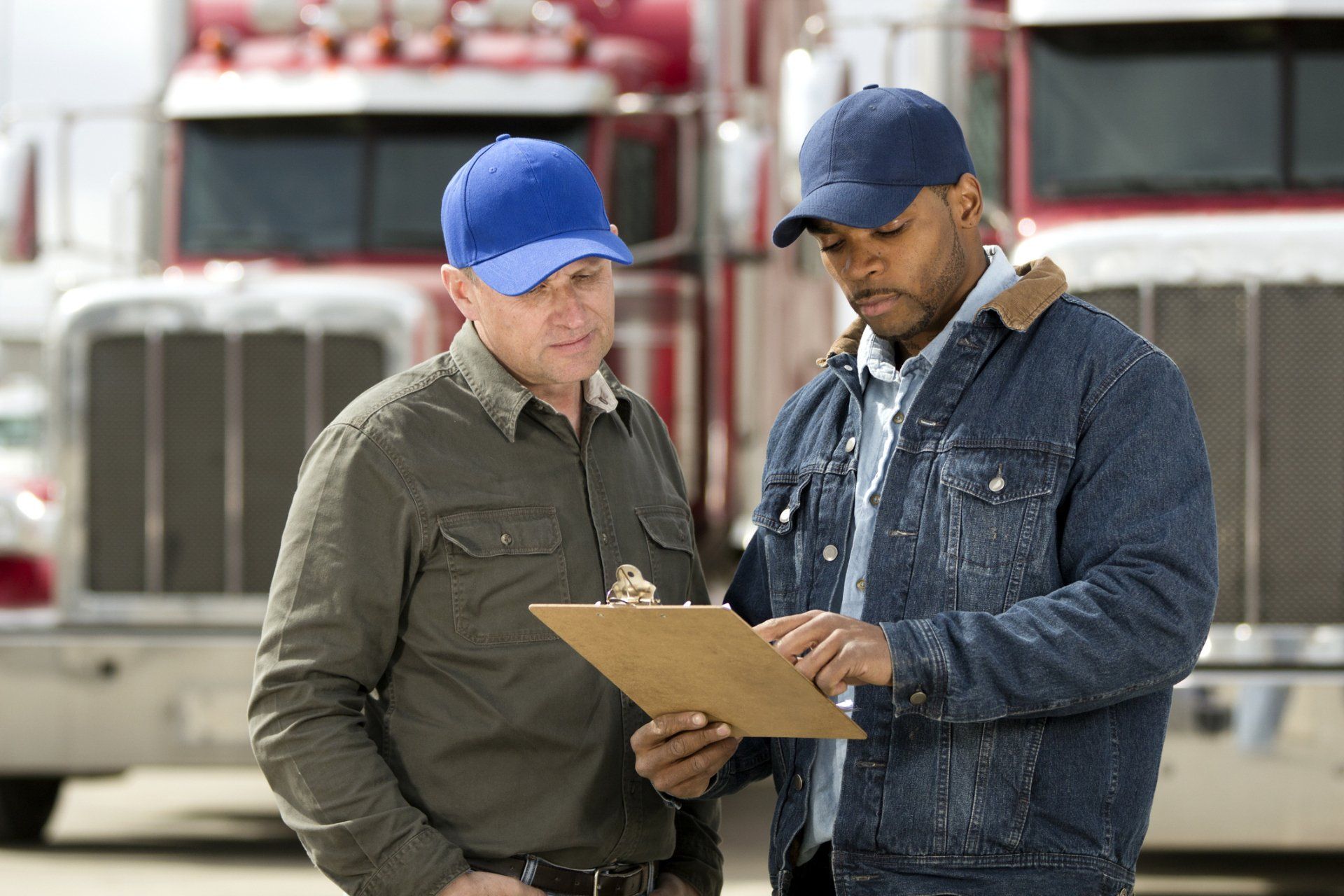 Truck drivers looking at clipboard — Riverdale, TN — Legasi Globe Logistics LLC