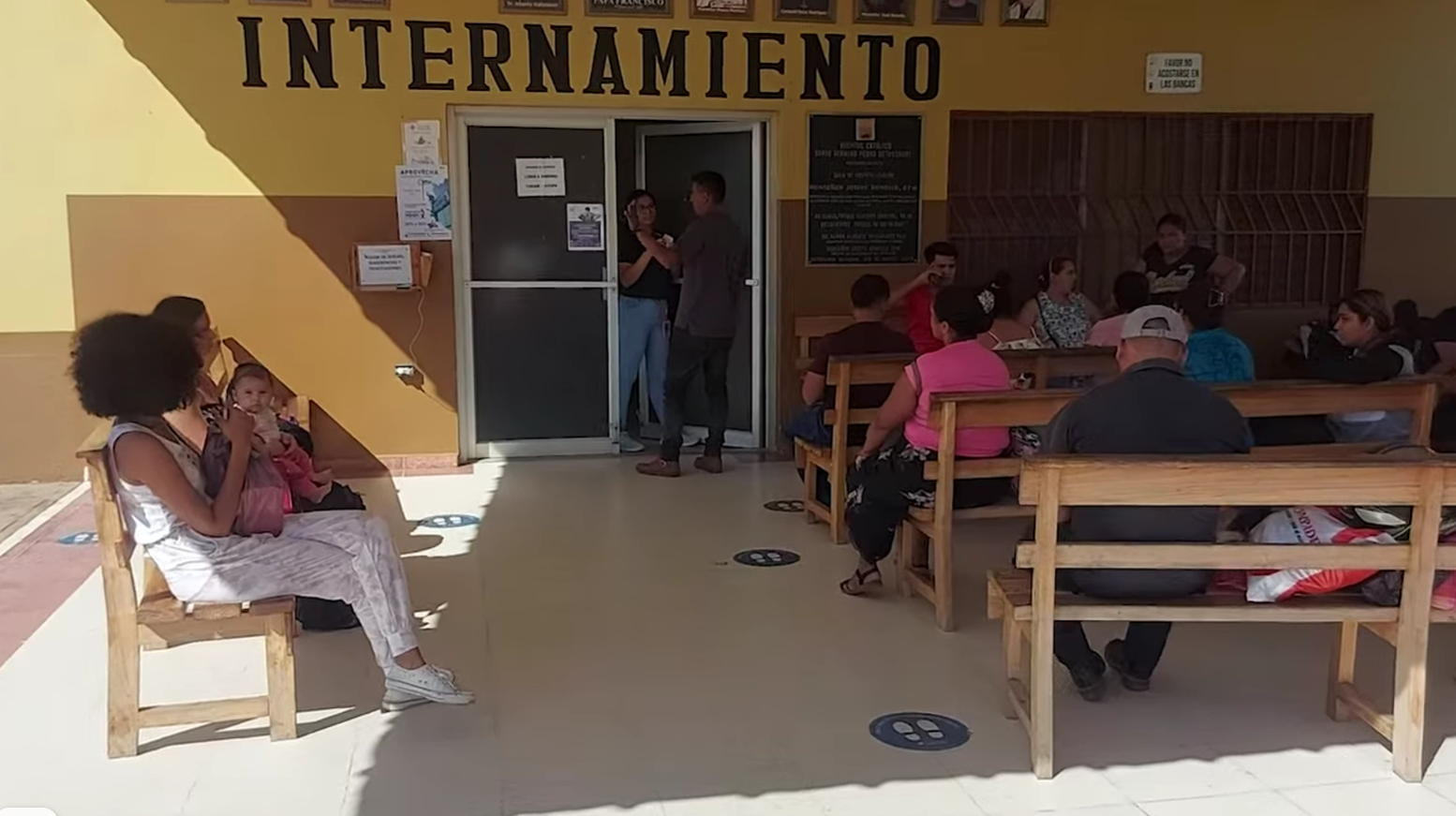 People at a building entrance labeled 