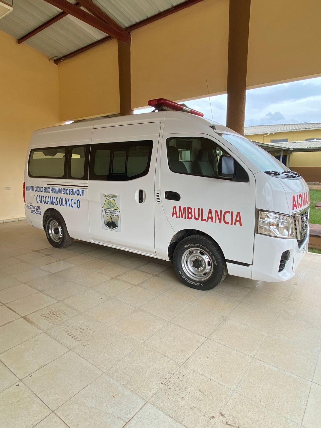 A white ambulance is parked in a parking lot.