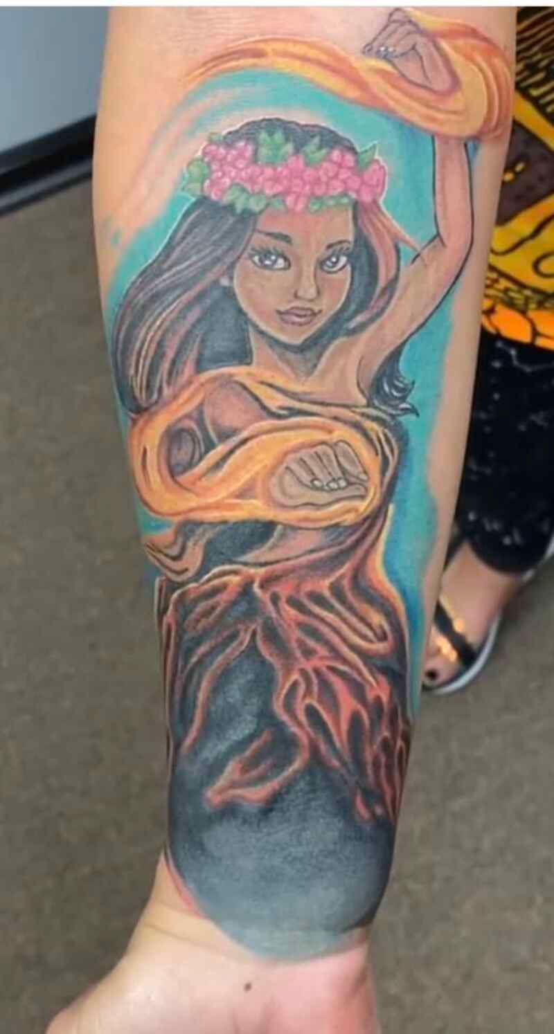 A woman has a tattoo of a mermaid on her arm