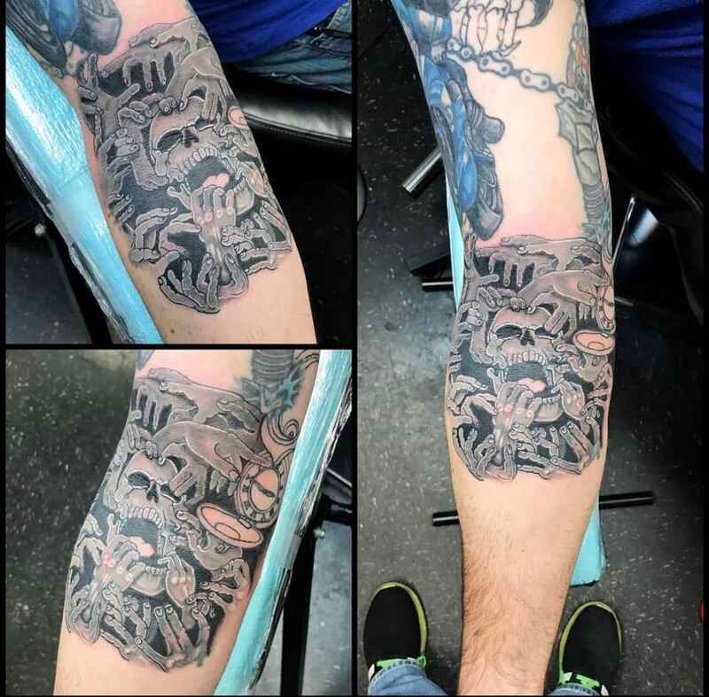 A man has a tattoo of a skull on his leg