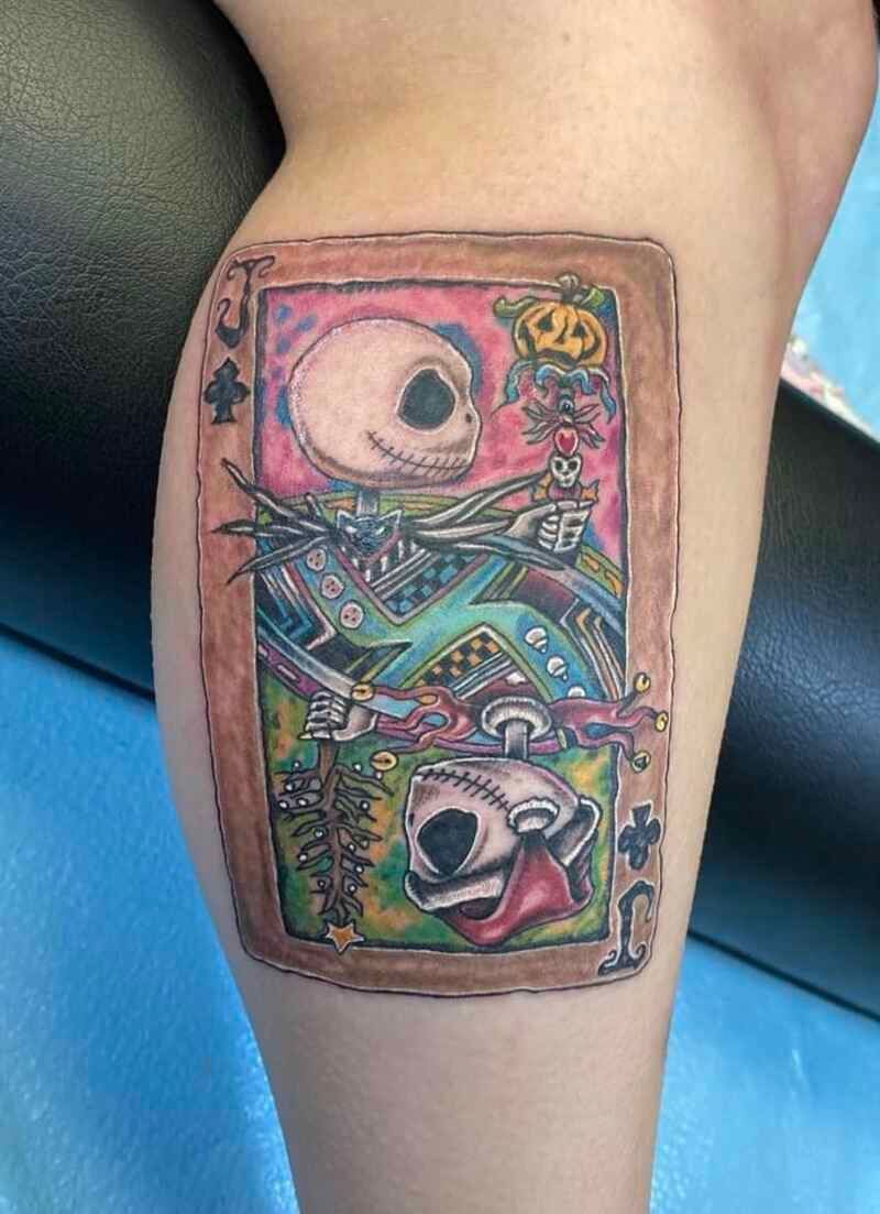 A person has a nightmare before christmas tattoo on their leg.