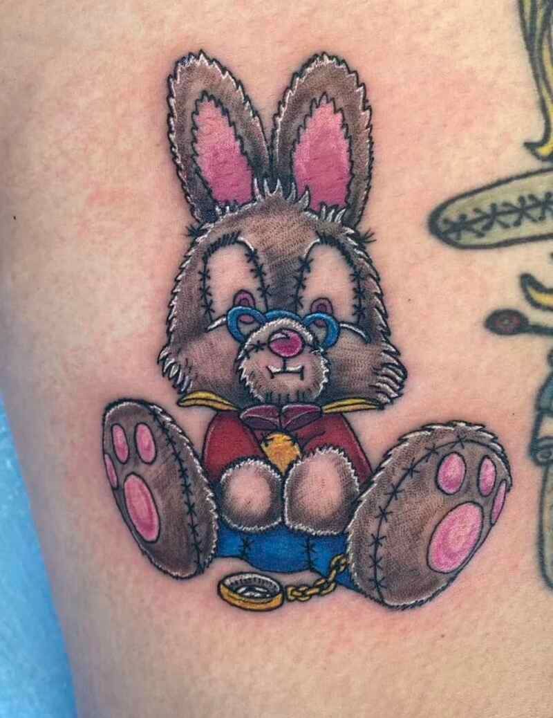 A tattoo of a rabbit wearing glasses and a bow tie