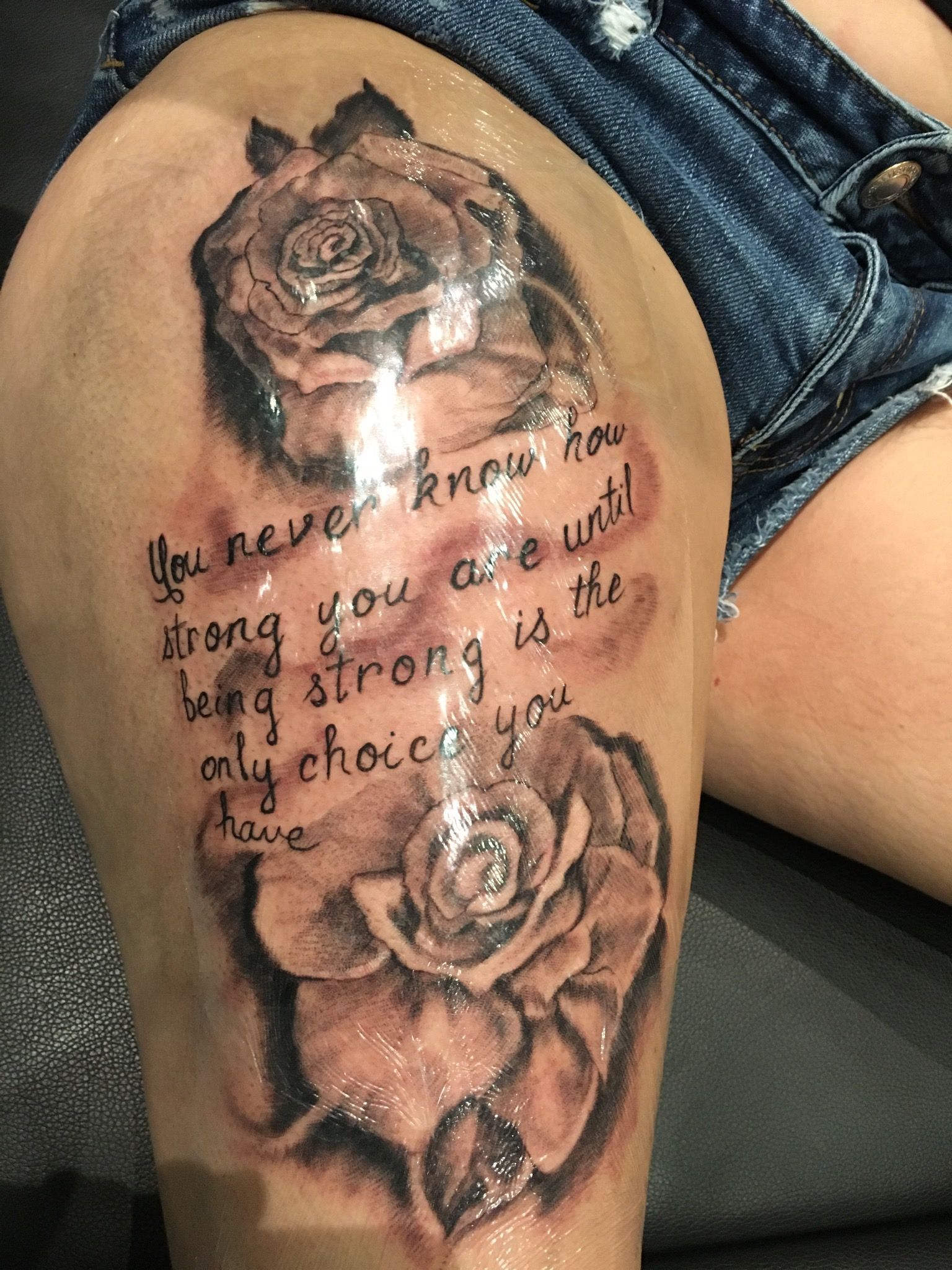 A woman has a tattoo on her thigh