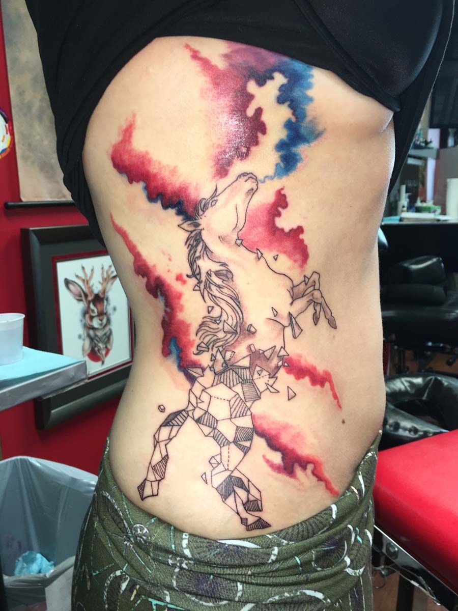 A woman has a colorful tattoo on her side