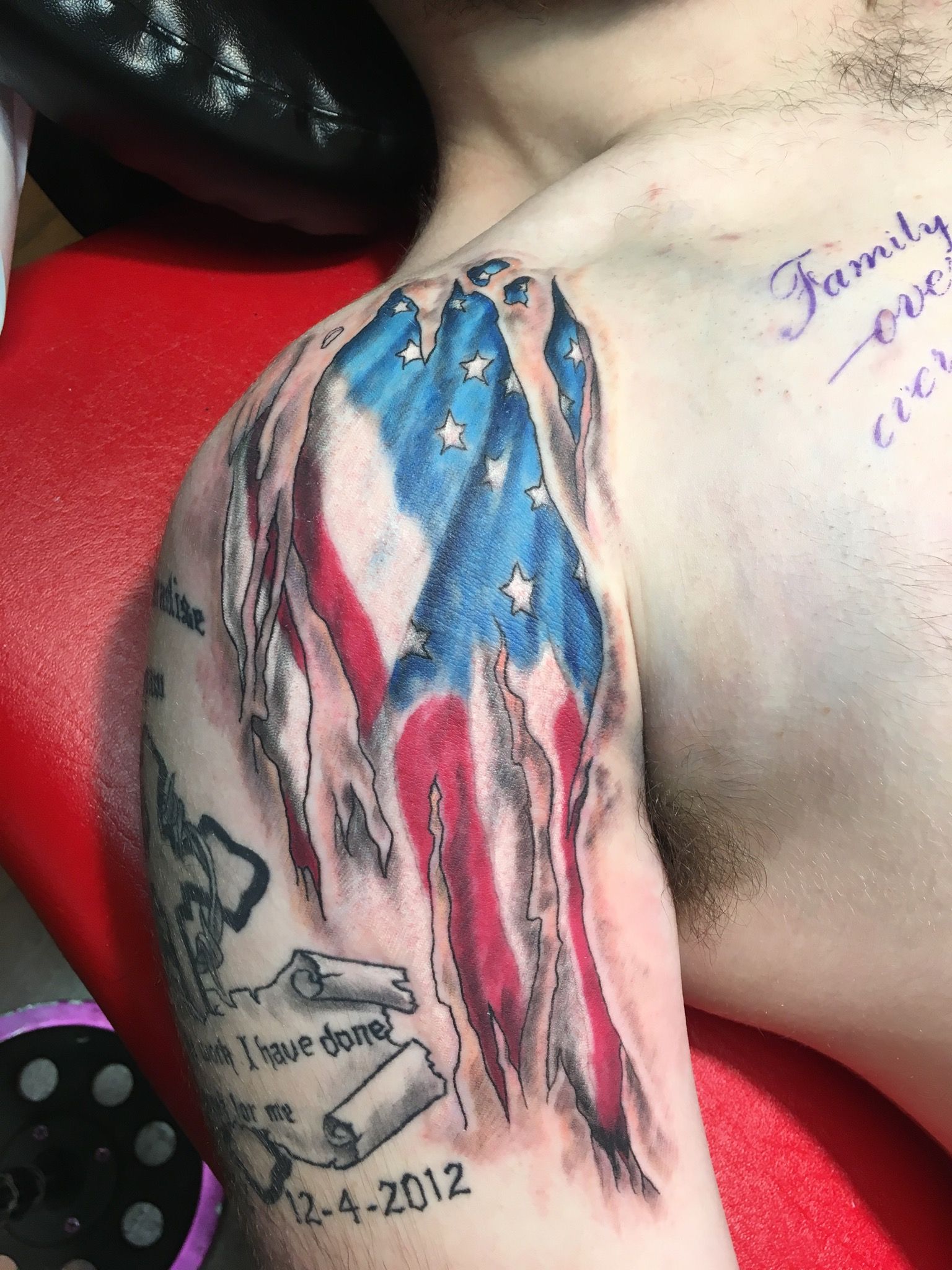 A man has a tattoo of an american flag on his arm