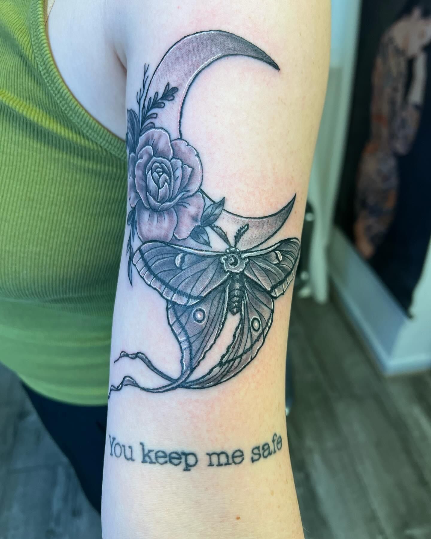 A woman has a tattoo on her arm that says you keep me safe