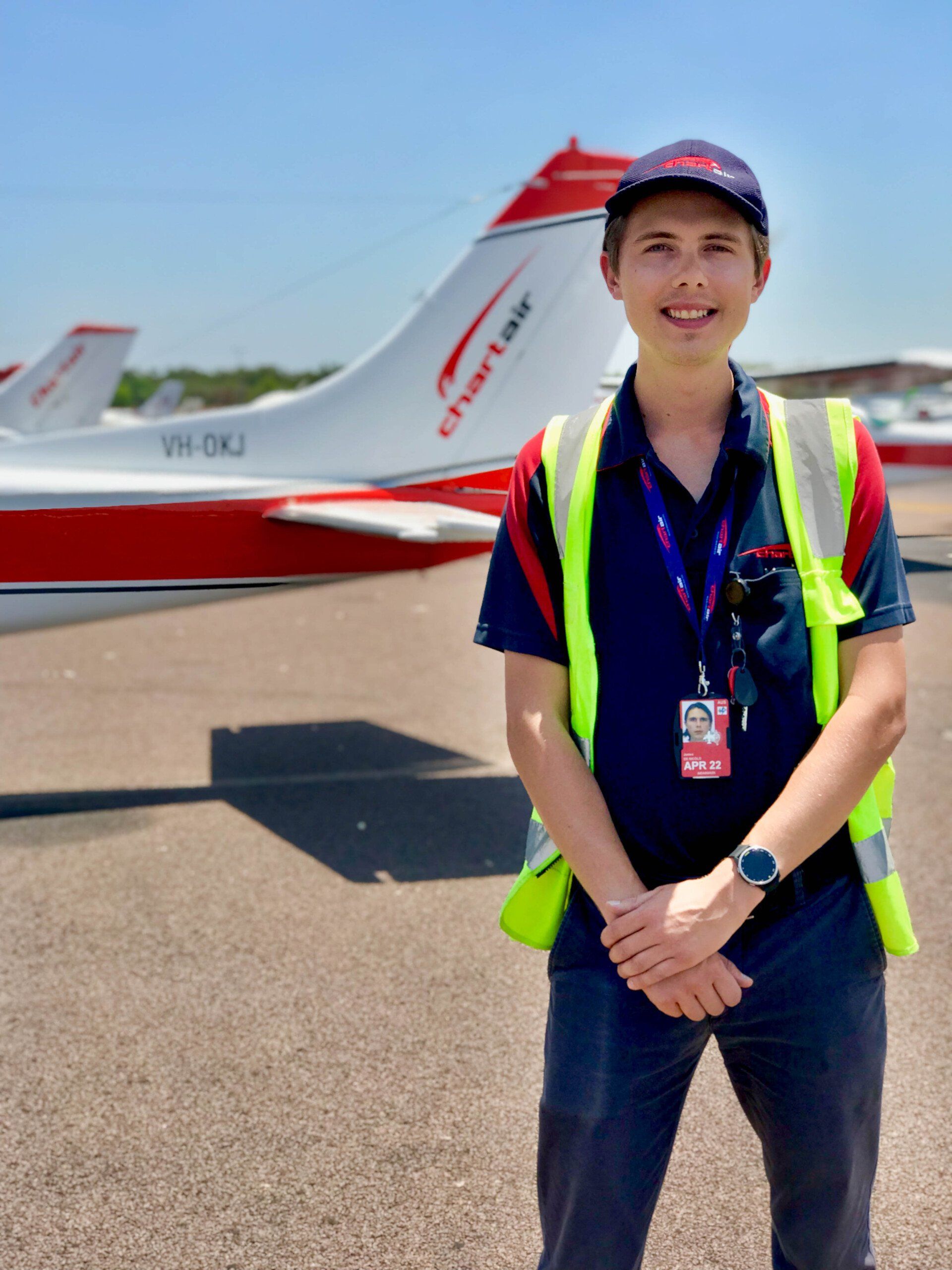 A male ground staff in front of airplane
