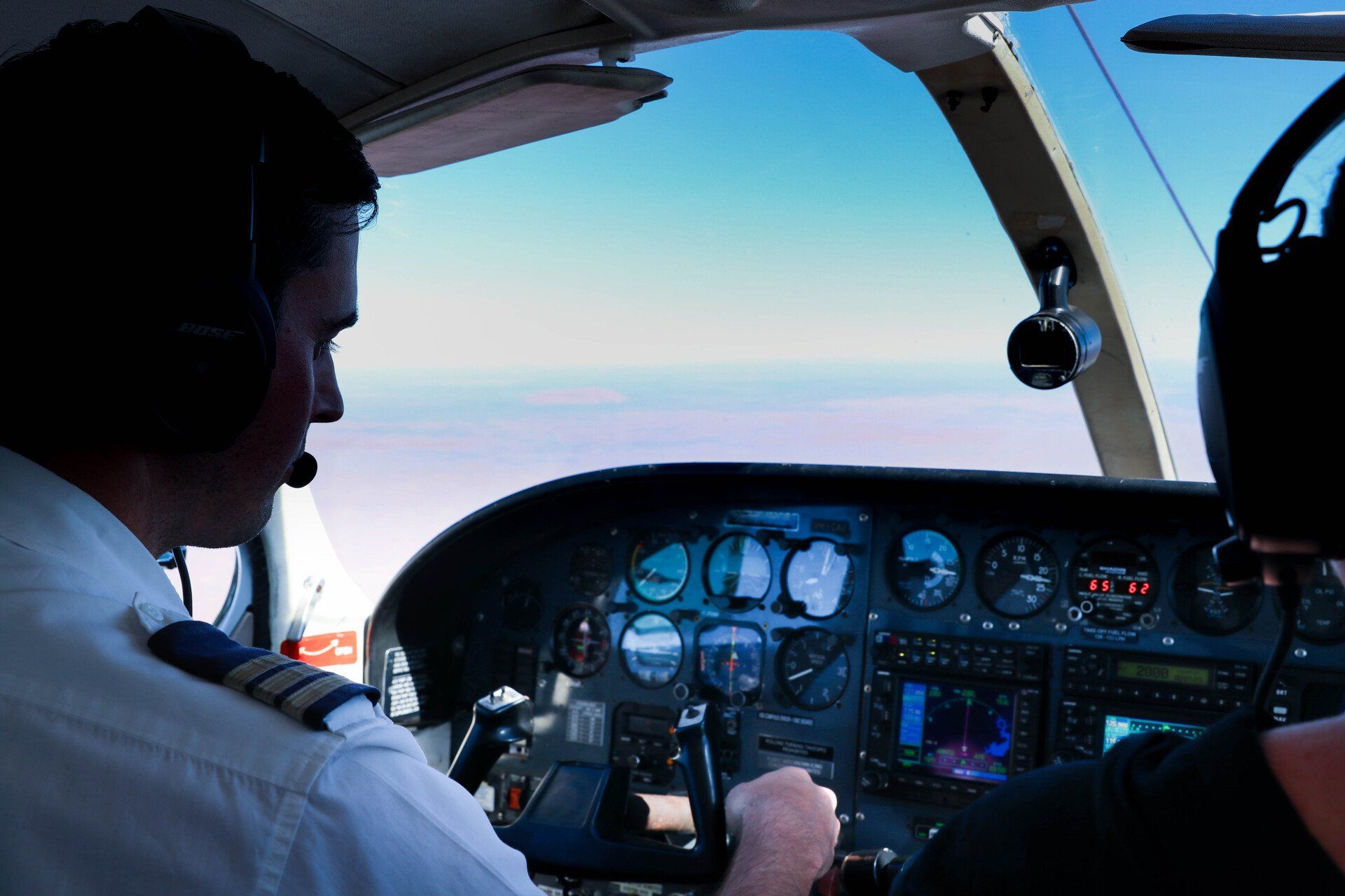 A male Chartair pilot is flying on the sky