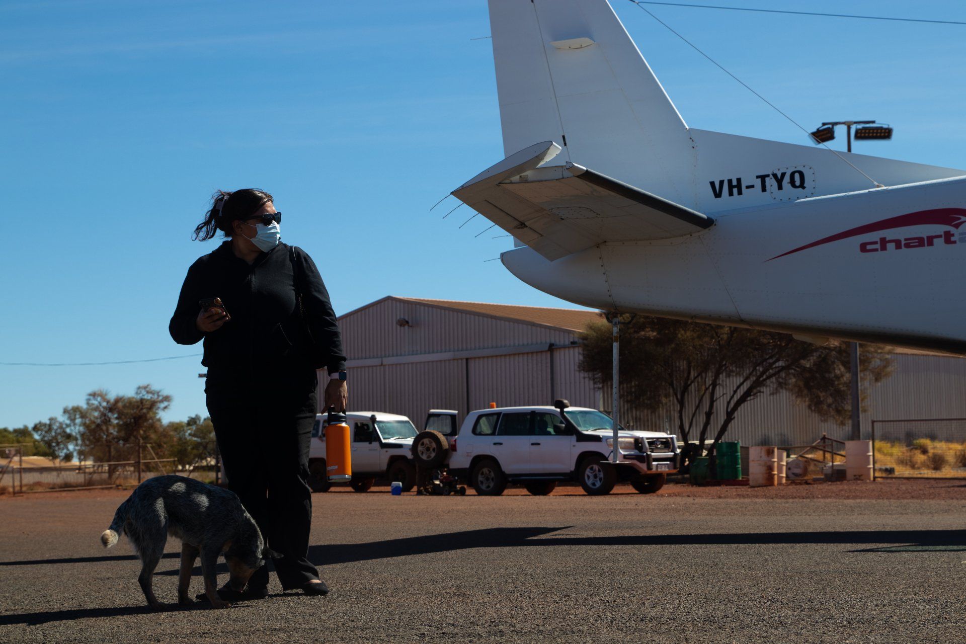 Chartair's team member Jaylene standing next to Chartair airplane in Warburton