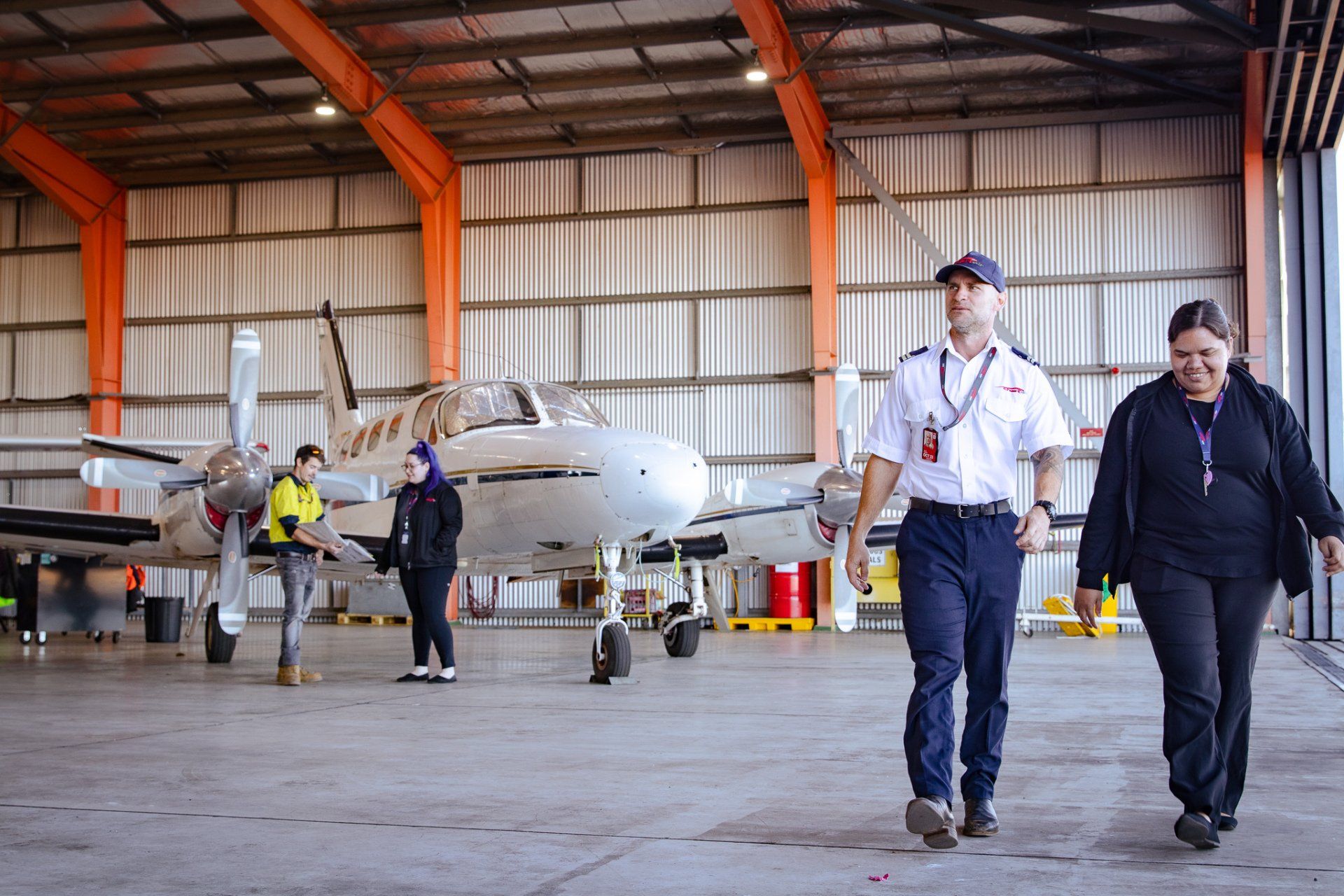 Chartair's team member Jaylene and colleagues walking in a hanger