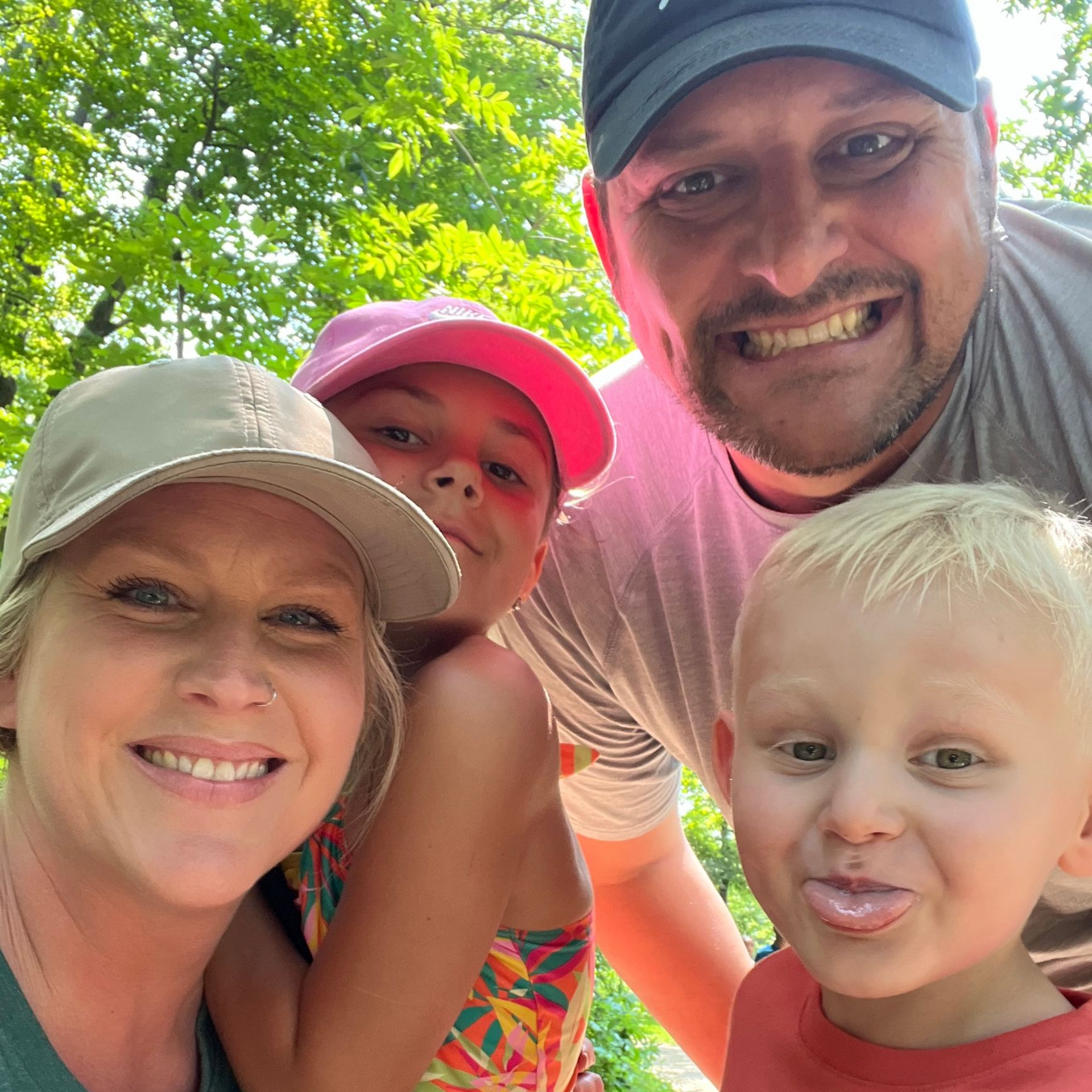 Tiny Strikers MN founders smiling with their two young children outdoors