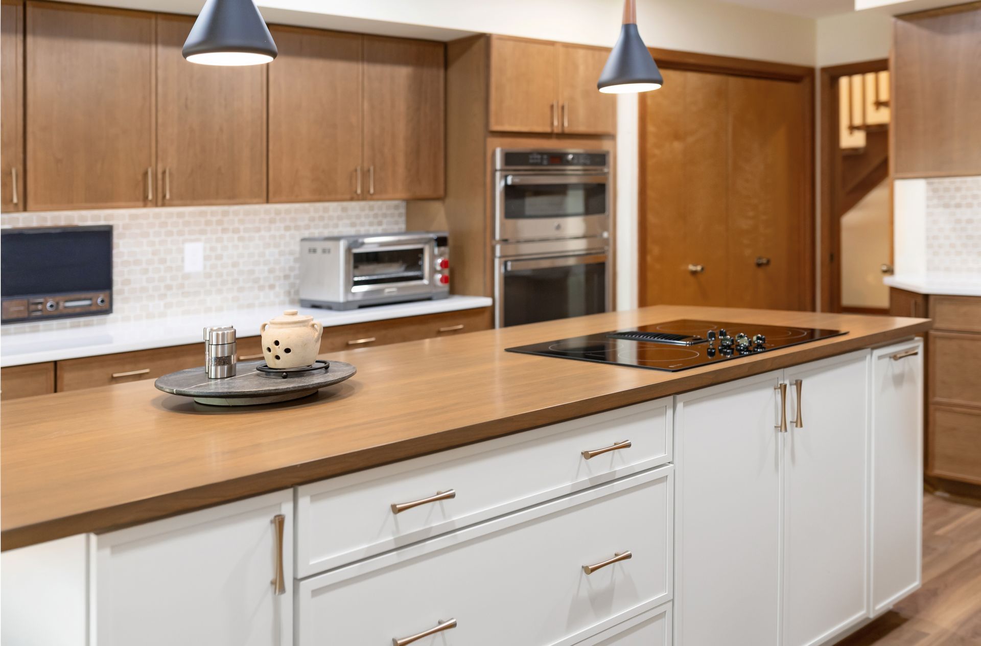 Waypoint Cabinetry in Cherry Amber  and Painted Vanilla Island Cabinets