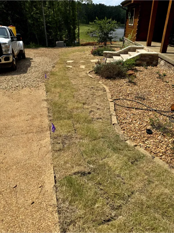 A white truck is parked in a driveway next to a house.
