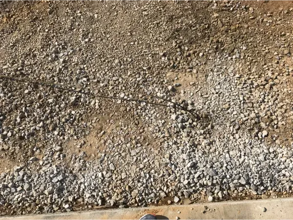 A pile of gravel is sitting on top of a concrete surface.
