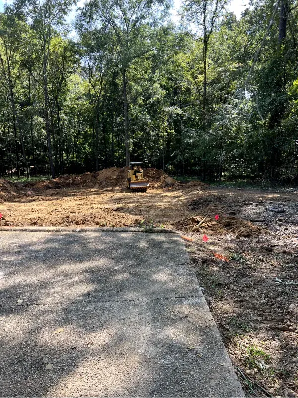 A construction site with a bulldozer in the middle of it.