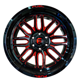 A close up of a red and black wheel on a white background.