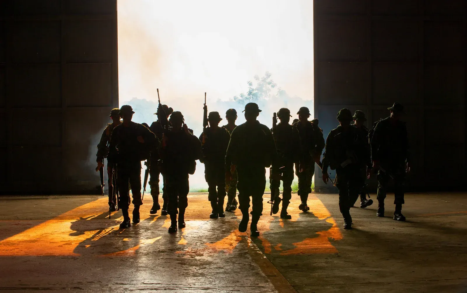 A group of soldiers are walking through a doorway.