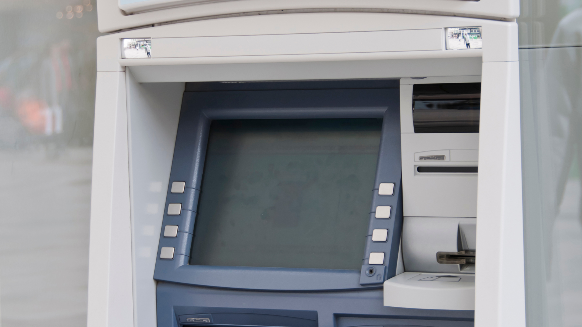ATM machine with a screen, keypad, and card reader.