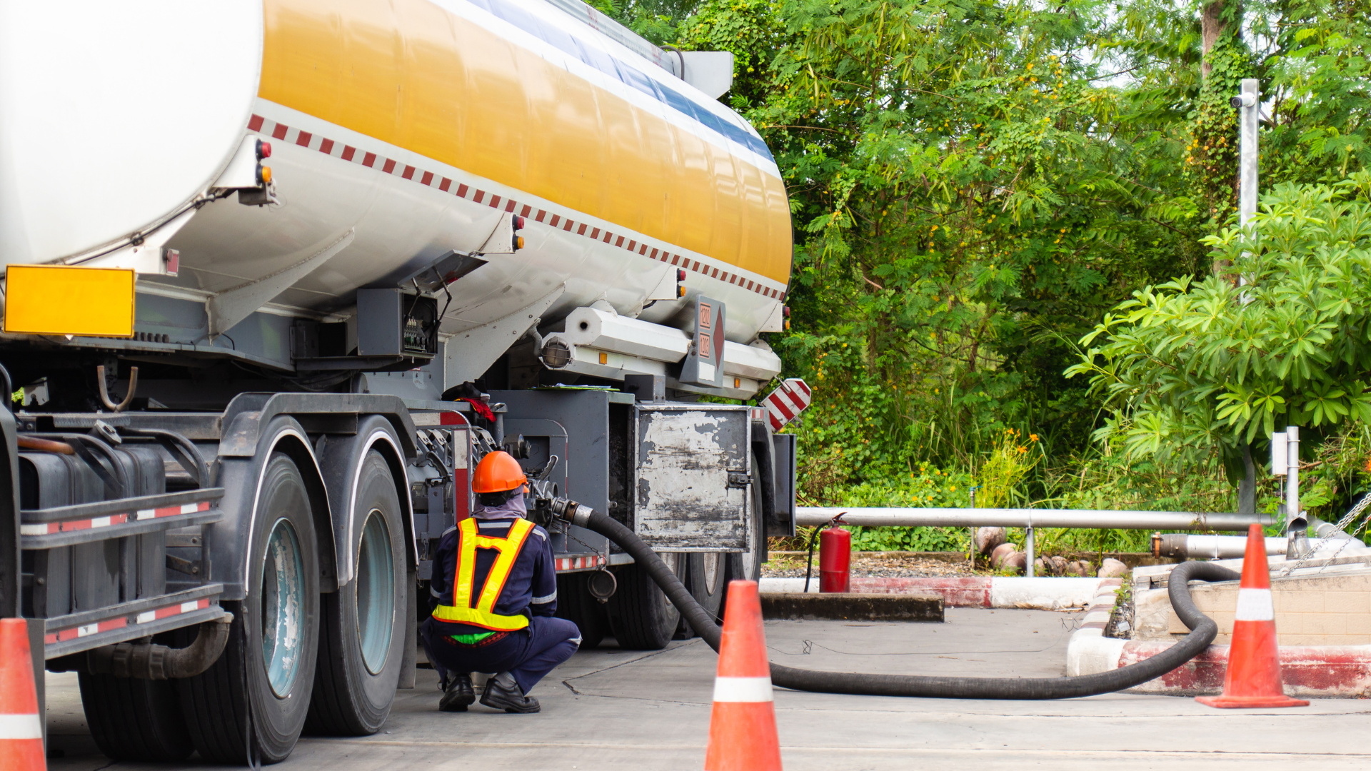 A man is holding a gas can in front of a car.