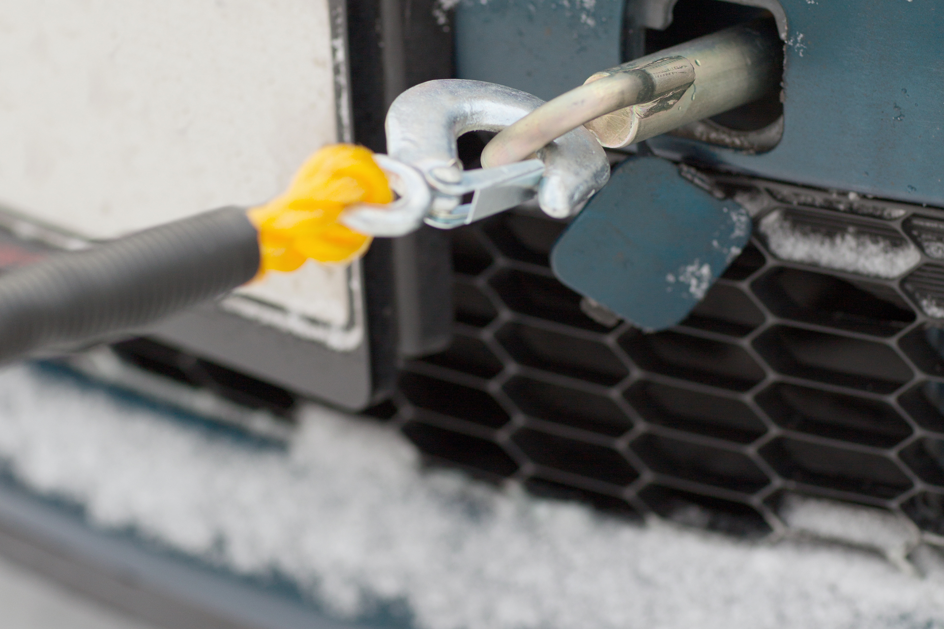 A person is towing a car with a tow hook.