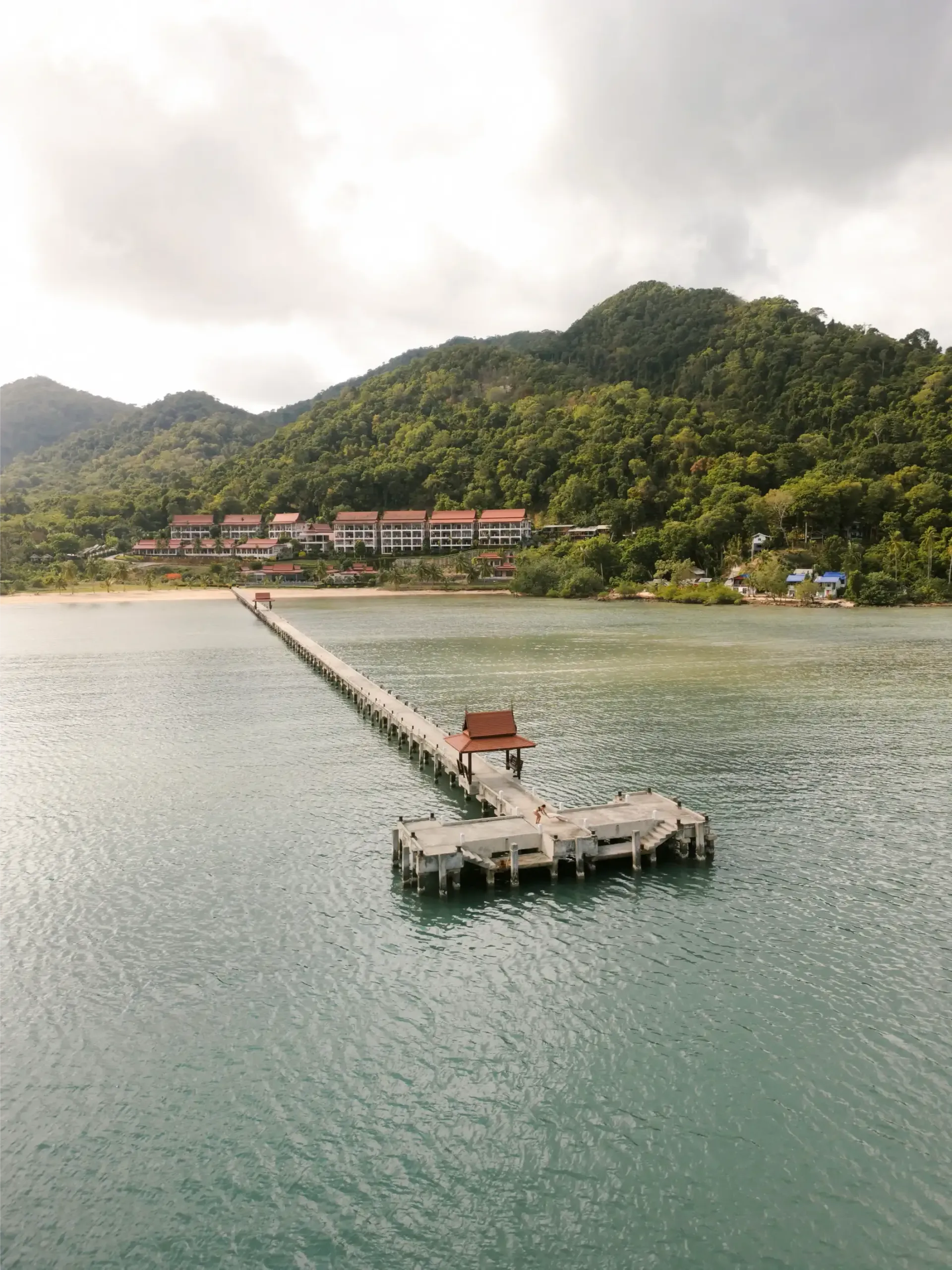 An aerial view of a dock in the middle of a body of water.