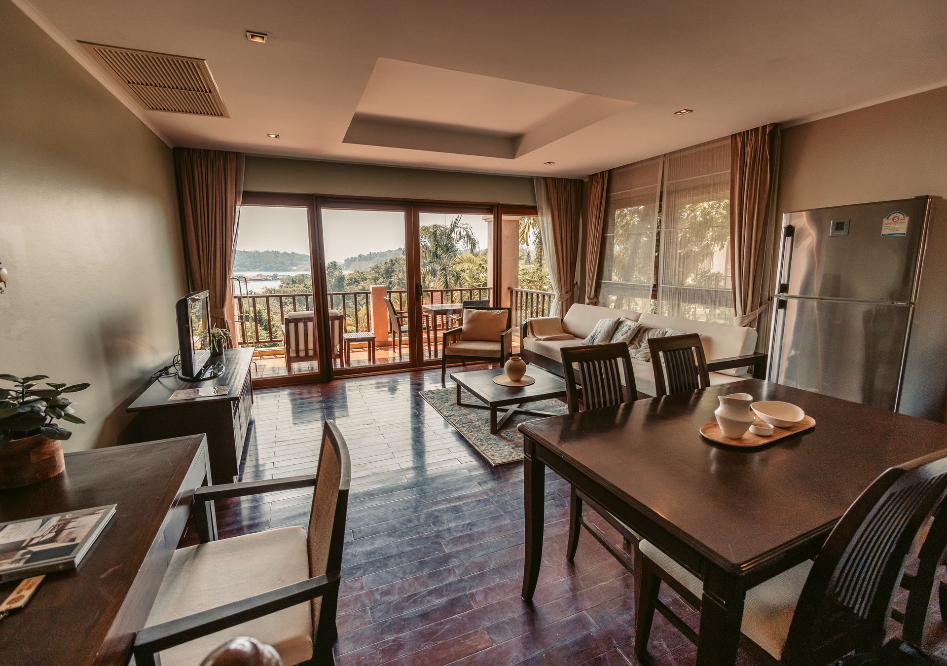 A bedroom with a large bed and a painting on the wall above it