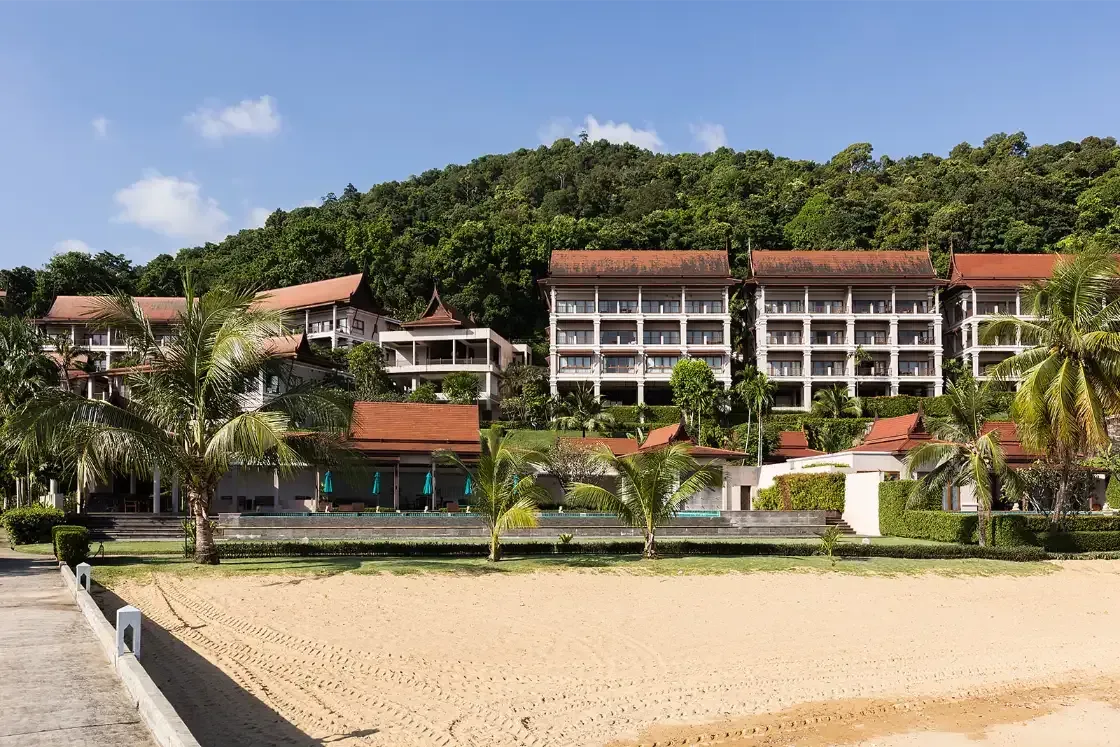A row of buildings sitting on top of a sandy beach.