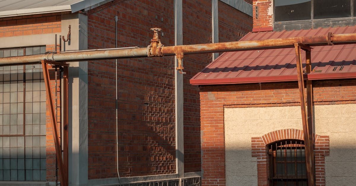 A brick building with a faucet on the side of it