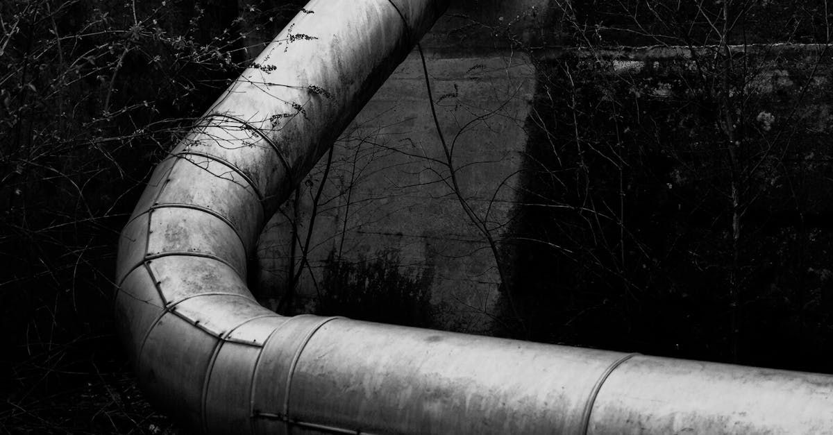 A black and white photo of a large metal pipe.