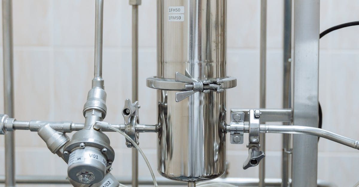 A close up of a stainless steel pipe with a valve attached to it.