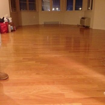 Wooden floor in an empty room, lit by sunlight.