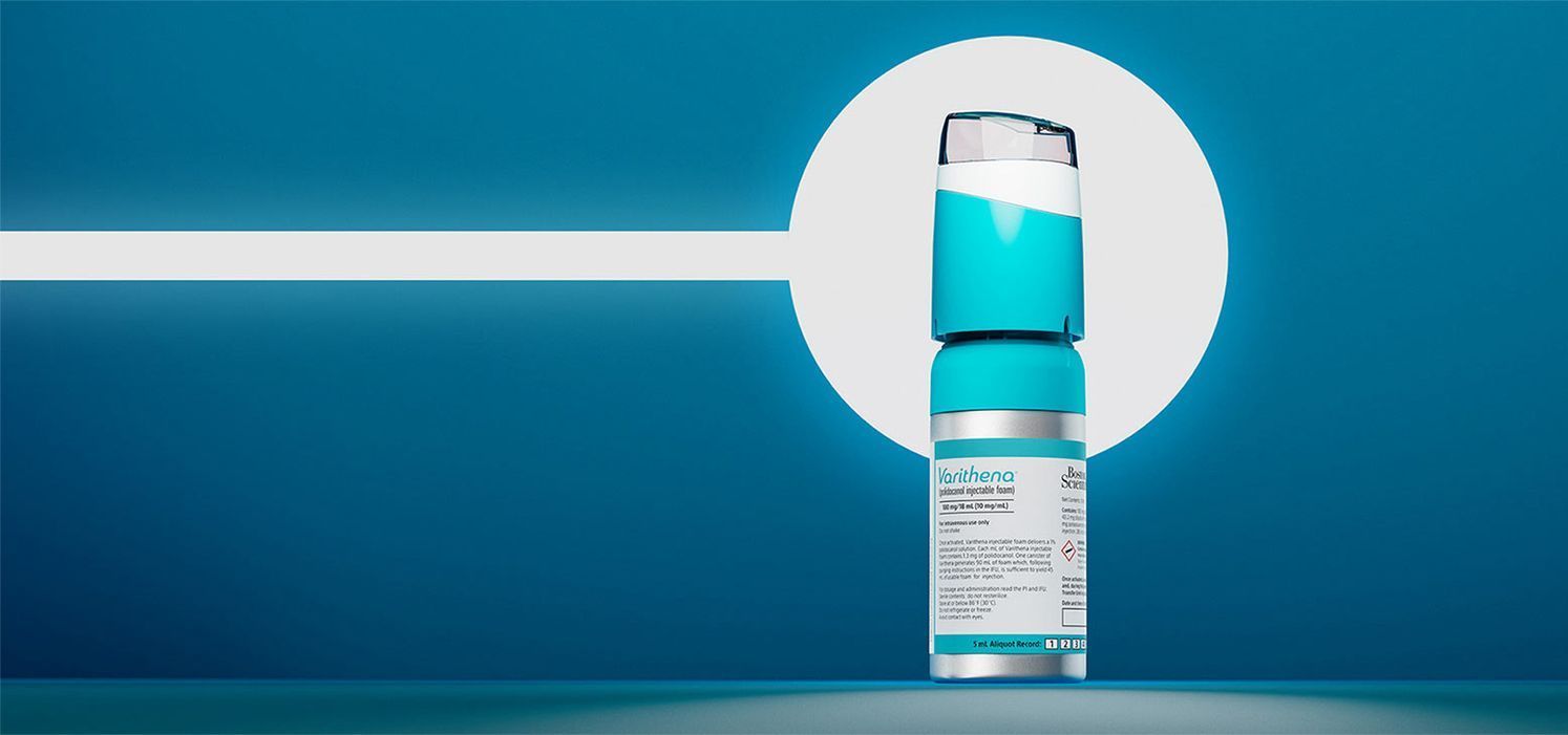 A close up of a vial of liquid on a blue background.